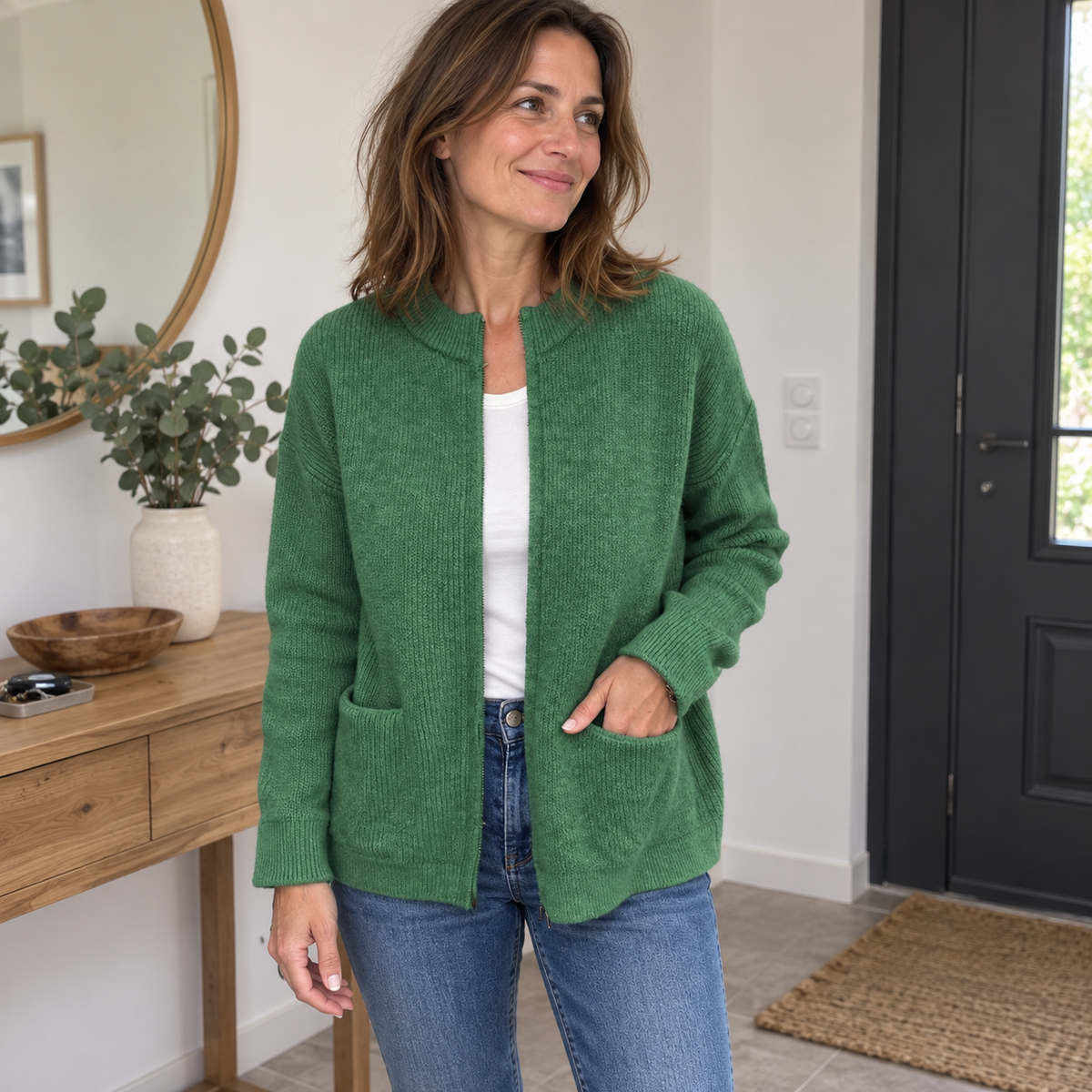 Veste en maille verte portée avec un jean à la maison